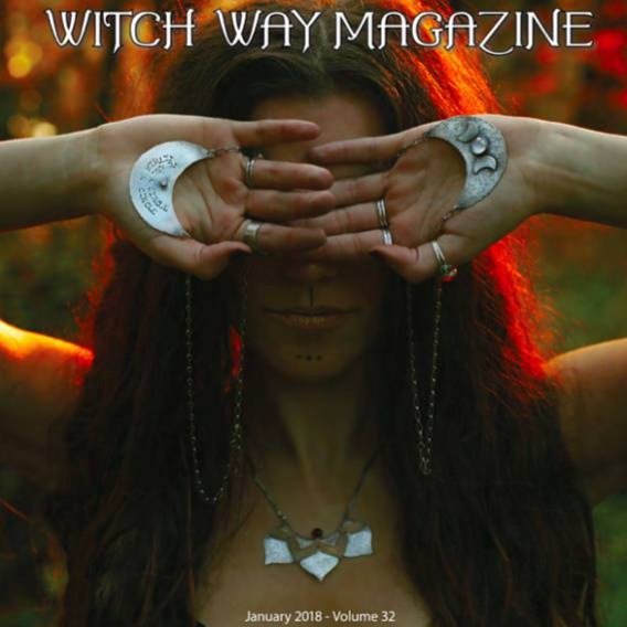 Lotus Statement Necklace with Garnet sterling silver and brass photographed on a model and published cover photo of Witch Way Magazine Winter 2018 issue