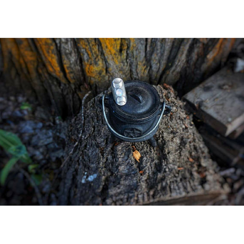 Triple Moon Goddess Ring with a Moonstone Moon Phases photographed on a cauldron 